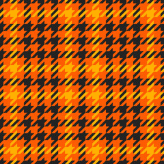 Goose foot. Halloween Pattern of crow's feet in orange, black and yellow cage. Glen plaid. Houndstooth tartan tweed. Dogs tooth. Scottish cage. Seamless fabric texture. Vector illustration