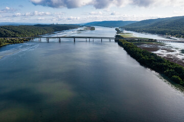 Ariel view of a bridge crossing the Tennessee River in Scottsboro Alabama with a nuclear power plant in the background.