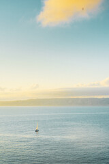 Sailboat in freedom in the middle of the ocean enjoying the immensity and force of nature between Mediterranean islands vertical