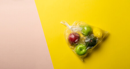 fresh fruit food in the plastic bag package. apple, orange, banana, avocado