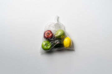 fresh fruit food in the plastic bag package. apple, orange, banana, avocado