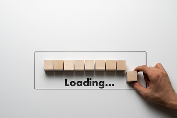 hand put a wooden cube in a row, loading progress bar