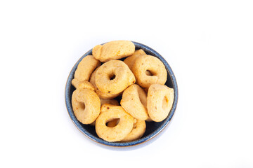 Tarallini or Taralli an Italian Snack Ring or Cracker Isolated on White in a Blue Pottery Bowl in a Flat Lay or Top Down View