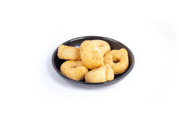 Tarallini or Taralli an Italian Snack Ring or Cracker Isolated on White in a Black Bowl in a Three Quarter or Side View Shot