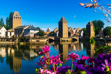 Picturesque Strasbourg cityscape overlooking medieval arched Ponts Couverts and watchtowers seen...