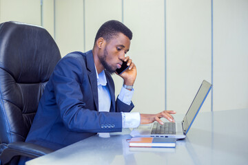 African young manager in the board room with a laptop