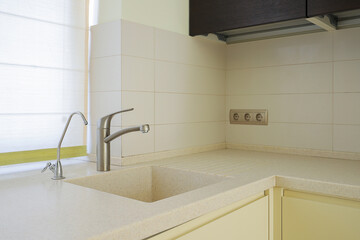 Faucet and sink in the kitchen interior