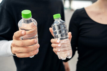 They drink clean water from two plastic bottles.