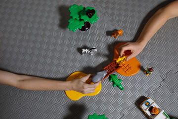 children's game with animal figurines, savannah, hands