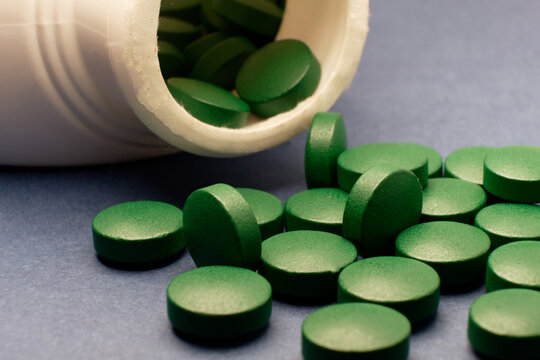 Green tablet spilled out the bottle