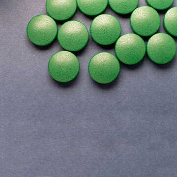 Top view of green tablets on blue background