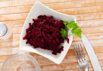 Popular russian salad, made from boiled grated beetroot, decorated with fresh herbs