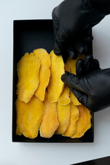 Dried mango in hand. Mango chunks.