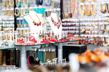 Variety of necklaces, bracelets, rings and earrings on mannequins on display in bijouterie salon