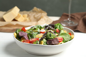 Delicious fresh carrot salad served on white wooden table, closeup
