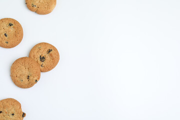 Tasty homemade cookies with raisins on white background, top view