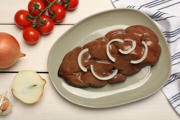 Fresh raw kidney meat and vegetables on white wooden table, flat lay