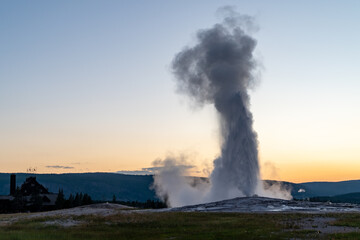 Sunset at Old Faithful Geyser in Yellowstone National Park