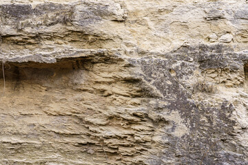 Texture cracked rock formation rock in the wild. Background with copy space