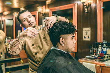 Barber Cutting Hair to a Client at Barber Shop