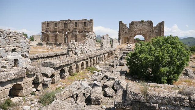 View of the ancient ruins of the roman bazilica and nymphaeum in the antiquity city of Aspendos, currently located near Antalya in the Serik district, Turkey.