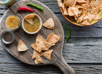 Top down view of fresh green salsa served with authentic tortilla chips.
