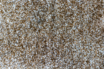Brown carpet texture background closeup view