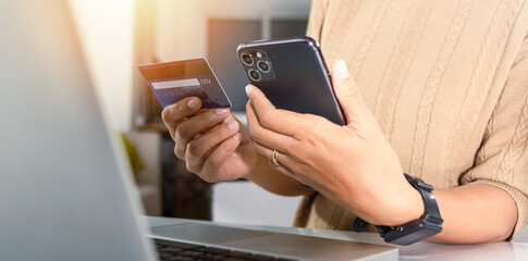 Woman hands holding credit card and smartphone with product purchase at home, Female register via credit cards on mobile phone to make digital payment security online, Internet online shopping concept