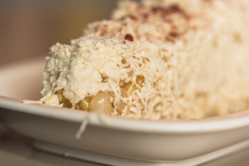 Close up view of a dish of corn with cheese