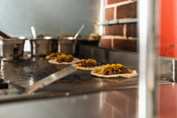 Kitchen with prepared corn and meat tacos