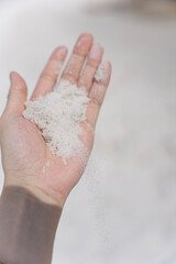 Hand Holding White Sand