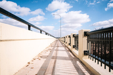 Fototapeta premium a low angle bridge with a bright sky and clouds. 
