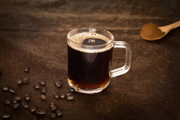 international coffee day, traditional colombian drink, mug and roasted coffee beans closeup