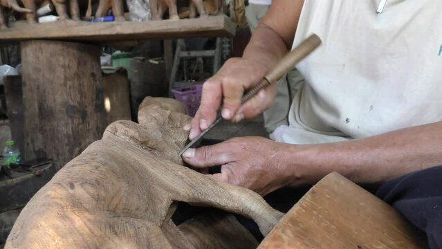 Artists are carving wood into beautiful shapes. Old wood carver. Art of the North of Thailand