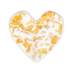 cornflakes cereal with milk in heart plate