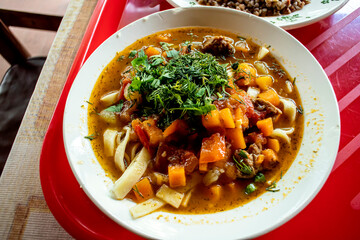 hot fresh lagman in a plate on the table