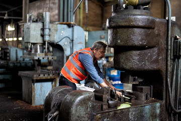 In maintenance workshop senior engineer fixing malfunction hydraulic compress machine stem 
