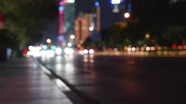 Defocused night road lights real time 4k footage in Shanghai. Night city road defocused headlights and taillights. Blurred lights road traffic transport, Blurry night city traffic. Night traffic jam.