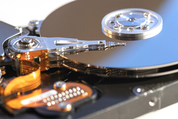 Disassembled hard drive from the computer, hdd with mirror effect. Opened hard drive from the computer hdd with mirror effects. Part of computer pc, laptop