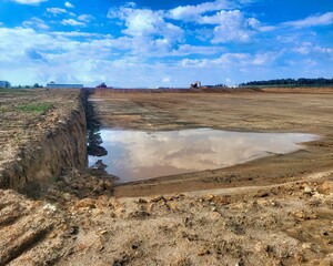Graded Landfill with Excavator/Digger in the Background