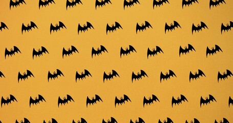 Composition of bat icons repeated on orange background