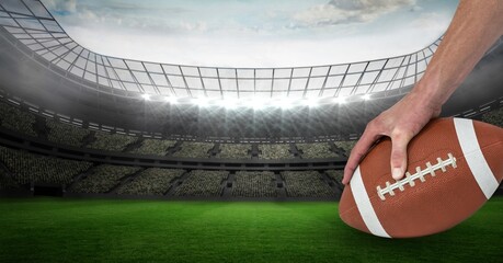 Composition of male rugby player holding rugby ball over sports stadium