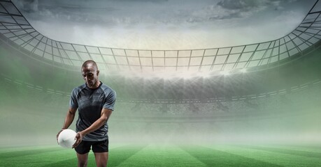 Composition of male rugby player holding rugby ball over sports stadium