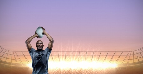 Composition of male rugby player holding rugby ball over sports stadium