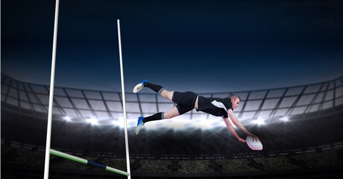 Composition of male rugby player diving holding ball on rugby pitch