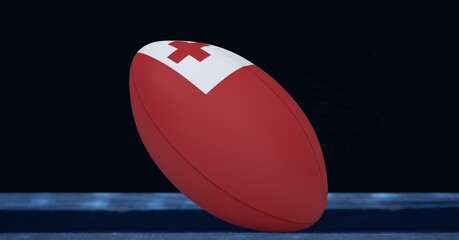 Composition of rugby ball decorated with the flag of tonga on black background