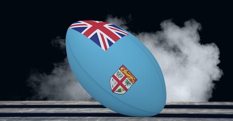Composition of rugby ball decorated with the flag of fiji on black background with smoke