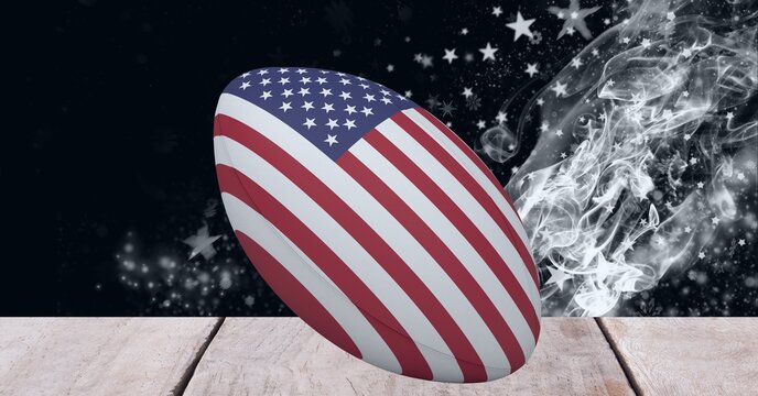 Composition of rugby ball decorated with the flag of usa on black background with smoke