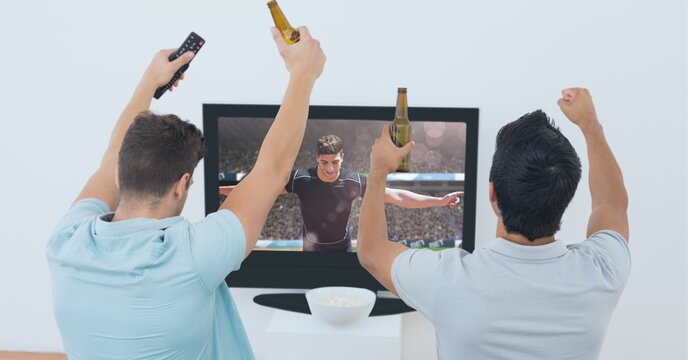 Composition of two male sports fans watching football match on tv