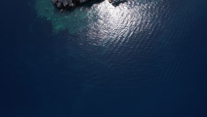 Birds Eye Aerial View of Sveti Stefan, Montenegro, Small Island With Old Stone Houses, Revealing Drone Shot